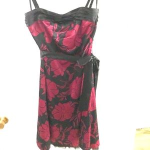 Black w/red floral pattern. Adj. straps removable. Back zipper removable belt